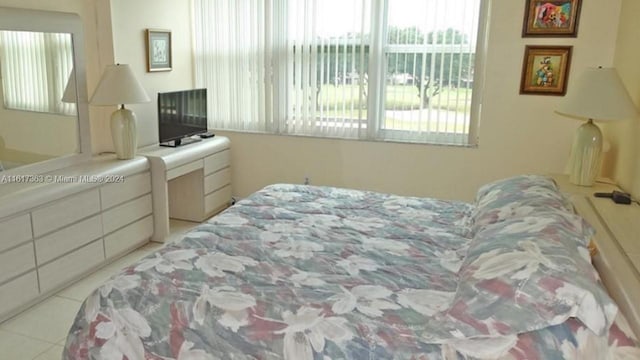 bedroom with multiple windows and light tile patterned floors