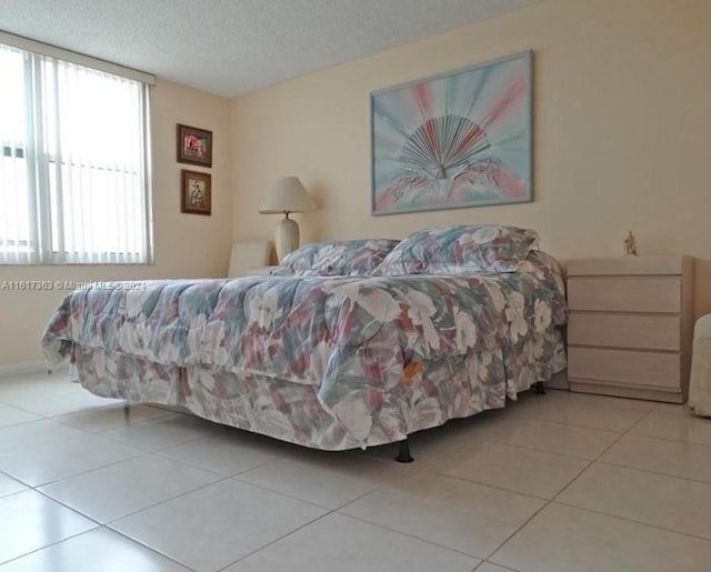 tiled bedroom with a textured ceiling