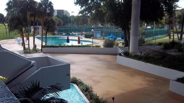 view of swimming pool with a patio area