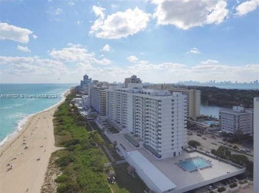 drone / aerial view featuring a view of the beach and a water view