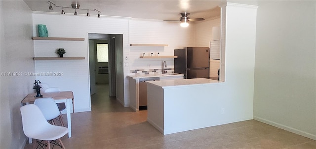 kitchen featuring appliances with stainless steel finishes, tasteful backsplash, sink, rail lighting, and ceiling fan