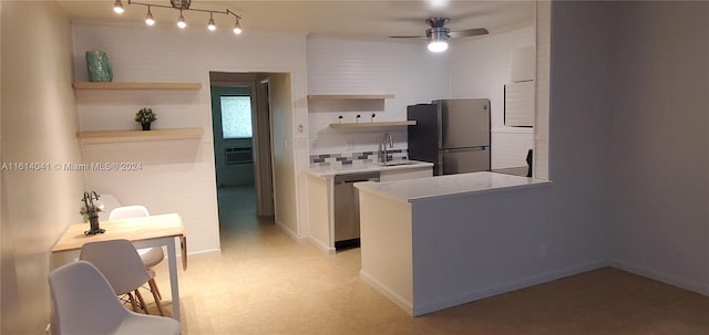 kitchen featuring track lighting, appliances with stainless steel finishes, sink, and ceiling fan