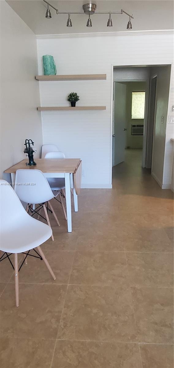 tiled dining area featuring track lighting