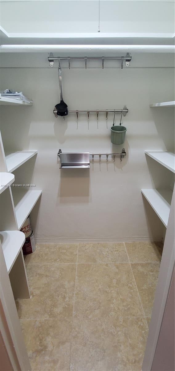 spacious closet featuring tile patterned floors