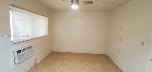 unfurnished room with light tile patterned flooring, a wall unit AC, and ceiling fan