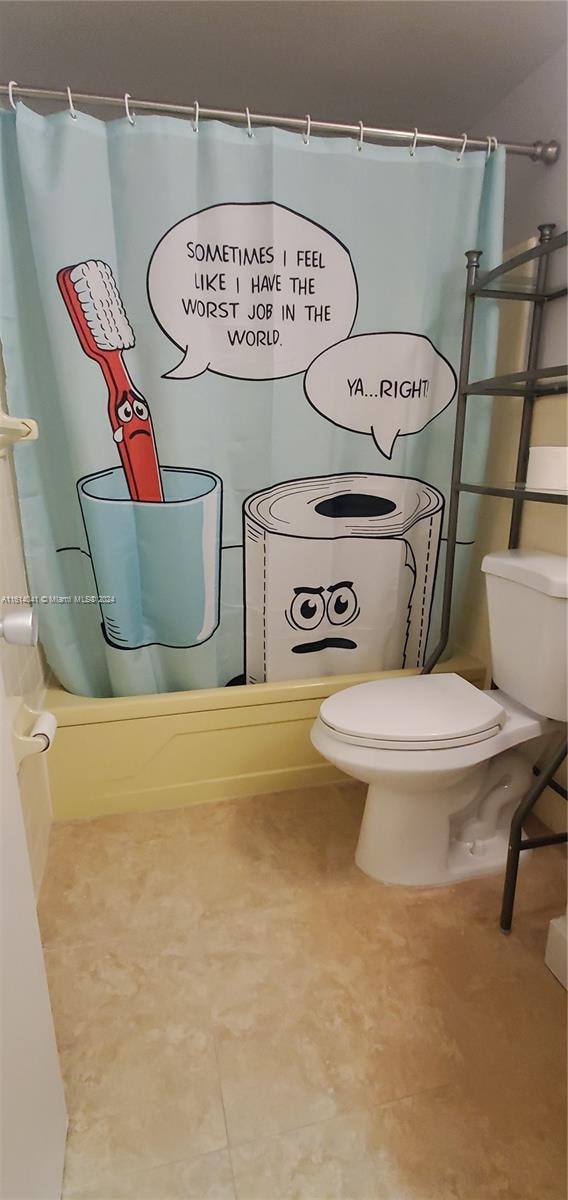 bathroom with tile patterned floors and toilet