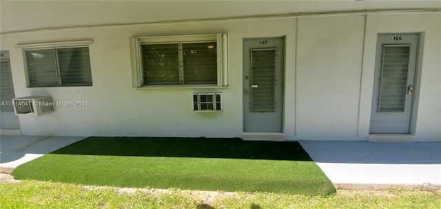 property entrance with a lawn