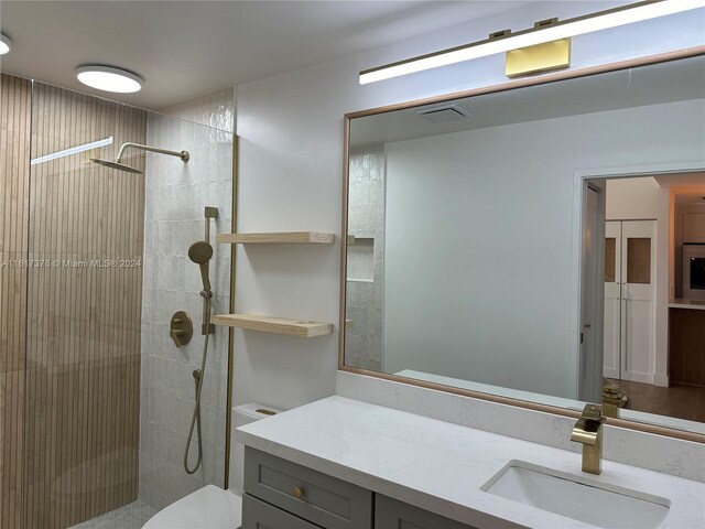 708 SE 3rd Ave Unit 201, Hallandale Beach, FL 33009 - full bath featuring visible vents, toilet, tiled shower, and vanity