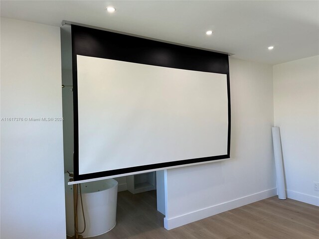 home theater room with wood-type flooring