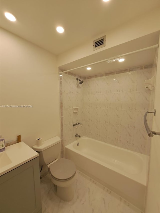 full bathroom featuring tiled shower / bath combo, vanity, tile patterned floors, and toilet