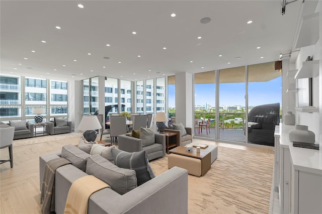 living room with light parquet floors and floor to ceiling windows