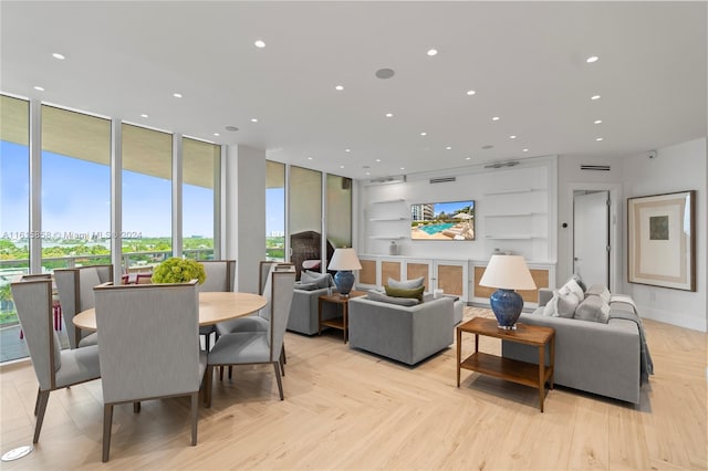 dining space featuring light parquet flooring and expansive windows