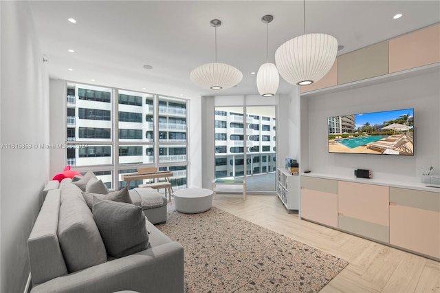 living room featuring light parquet flooring and a wall of windows