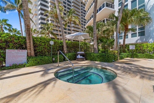 view of swimming pool featuring a community hot tub