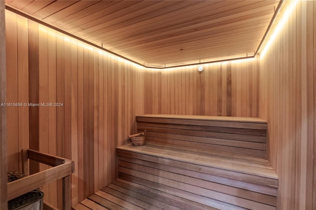 view of sauna / steam room featuring wood ceiling and wood walls