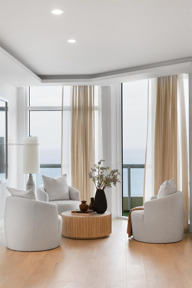 living room featuring wood-type flooring and expansive windows