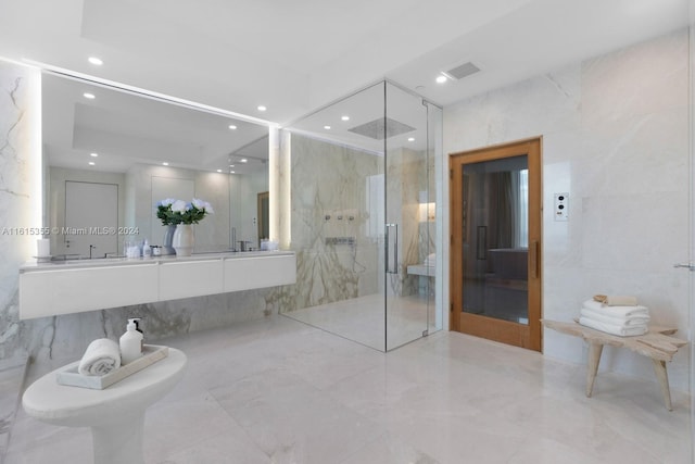 bathroom featuring a bidet, walk in shower, tile patterned flooring, and tile walls