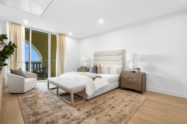 bedroom featuring light hardwood / wood-style floors and access to exterior