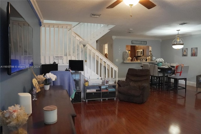 living room featuring ceiling fan, ornamental molding, and dark wood-type flooring