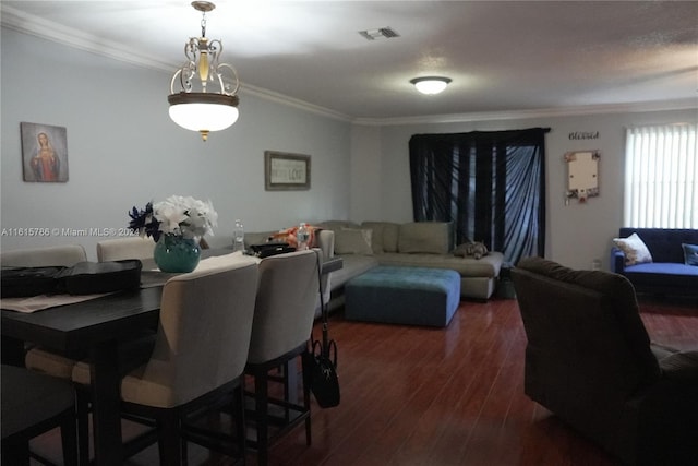 dining room with crown molding, dark hardwood / wood-style flooring, and a textured ceiling