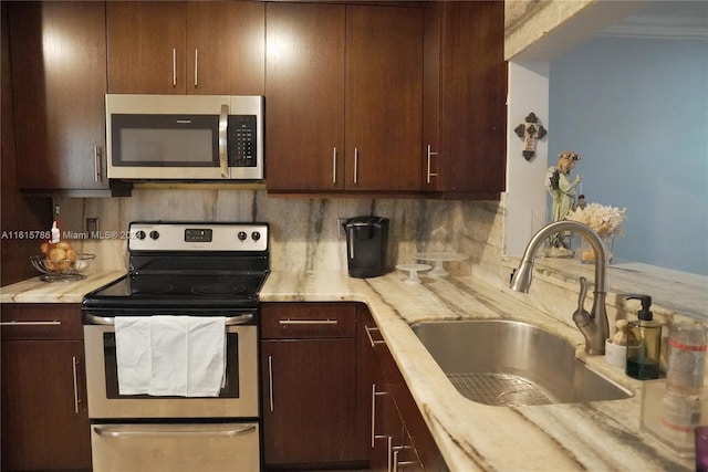 kitchen featuring decorative backsplash, sink, dark brown cabinets, and stainless steel appliances