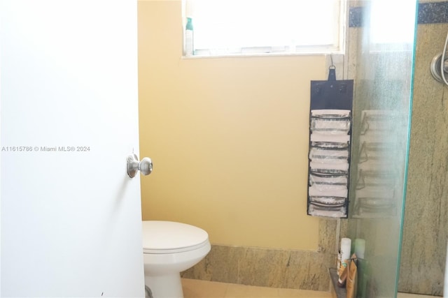 bathroom with tile patterned floors and toilet