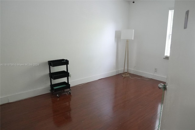 spare room featuring dark wood-type flooring