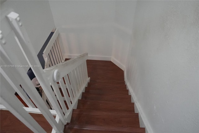 stairway featuring hardwood / wood-style flooring