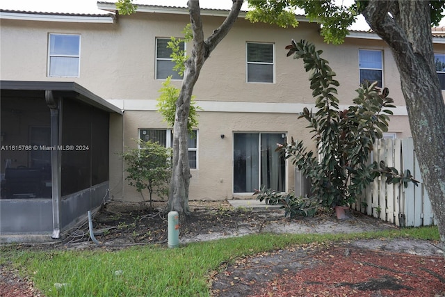 rear view of house featuring a sunroom