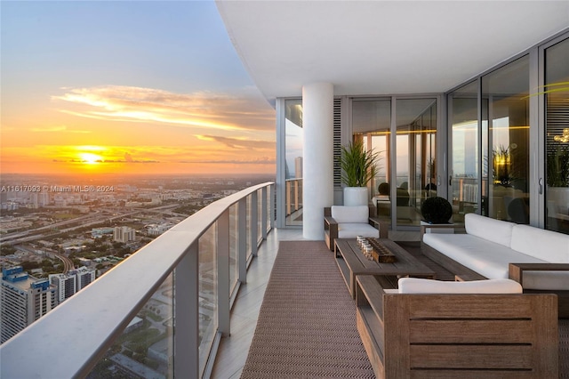 balcony at dusk featuring an outdoor living space