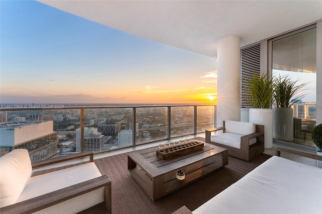 balcony at dusk with an outdoor living space with a fire pit