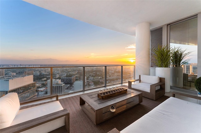 851 NE 1st Ave Ph 5312, Miami, FL 33132 - balcony at dusk with outdoor lounge area and a view of city