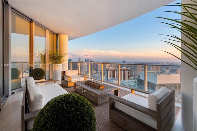 balcony at dusk featuring an outdoor hangout area