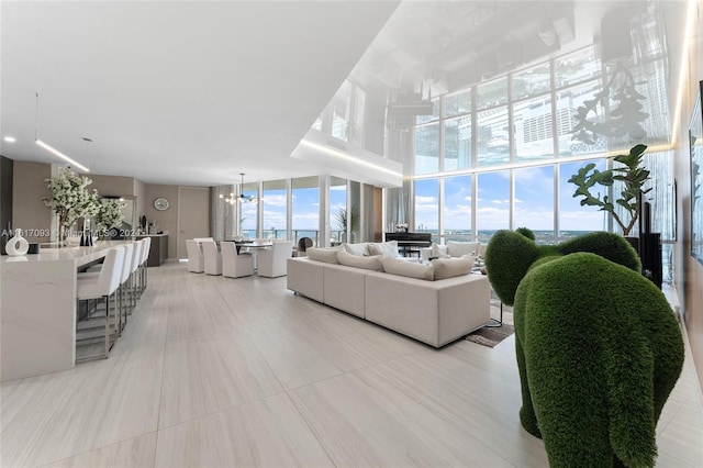 tiled living room featuring an inviting chandelier and expansive windows