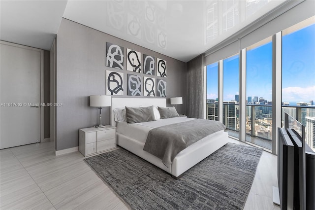 bedroom with access to outside and tile patterned flooring