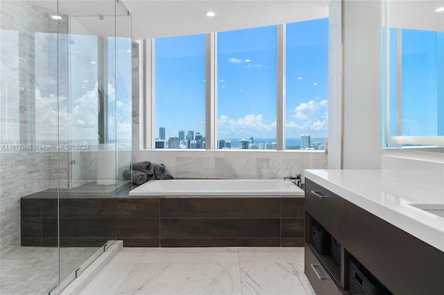 bathroom with independent shower and bath, vanity, and tile patterned floors