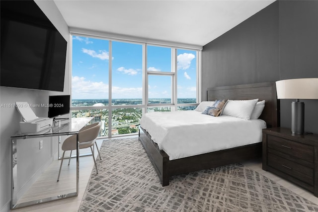 bedroom featuring light hardwood / wood-style floors and expansive windows