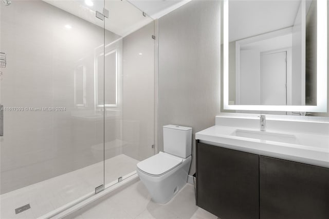 bathroom with tile patterned flooring, a shower with shower door, toilet, and vanity