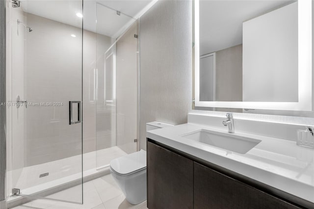 bathroom featuring vanity, a shower with shower door, toilet, and tile patterned flooring