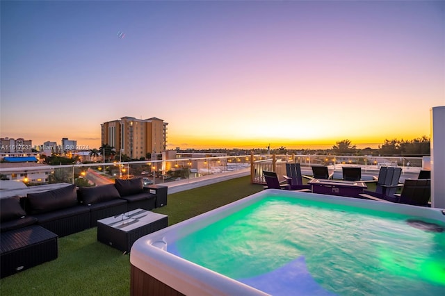 patio terrace at dusk featuring outdoor lounge area