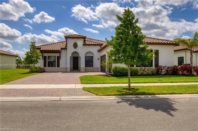 mediterranean / spanish-style house featuring a front yard