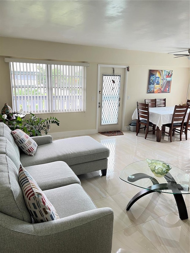 living room with tile patterned floors and ceiling fan