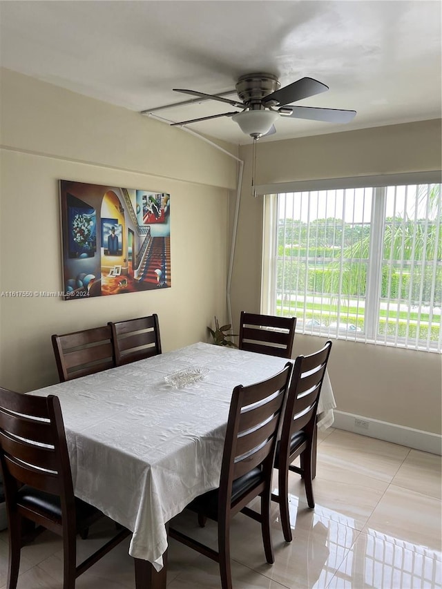 dining area with tile patterned flooring and ceiling fan