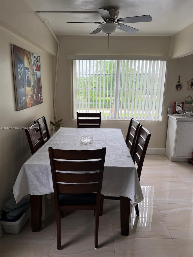 tiled dining area featuring ceiling fan