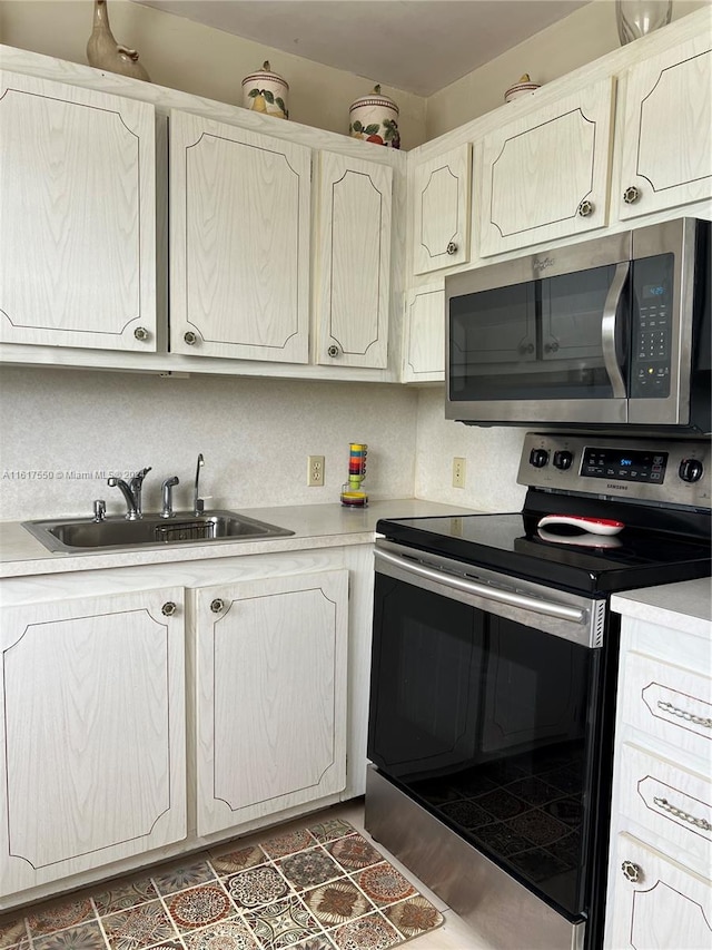 kitchen featuring stainless steel appliances, tasteful backsplash, and sink