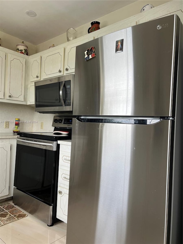 kitchen with sink, stainless steel appliances, and white cabinetry