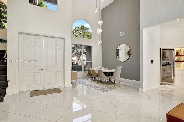 tiled foyer with a high ceiling