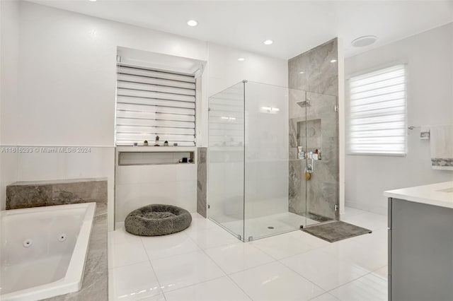 bathroom featuring tile patterned floors, vanity, and independent shower and bath