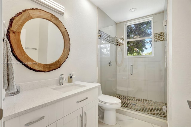 bathroom with a shower with door, toilet, vanity, and tile patterned flooring