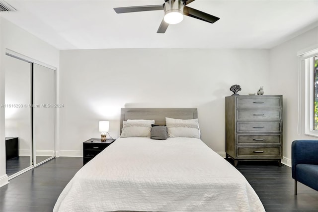 bedroom with ceiling fan, a closet, and dark hardwood / wood-style floors